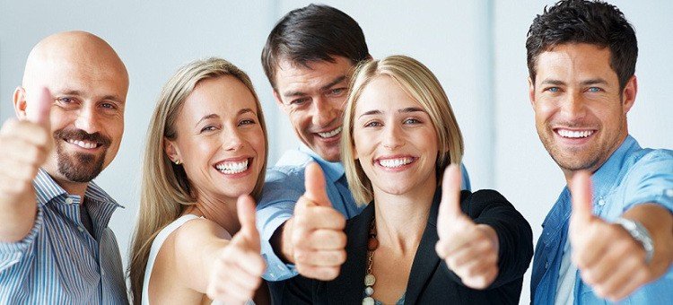 Business approval - Portrait of confident young colleagues with thumbs up sign